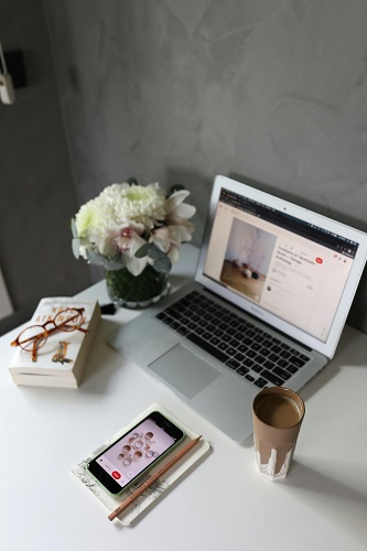 A professional workspace with a laptop displaying a business website, surrounded by office essentials, symbolizing business development and growth.