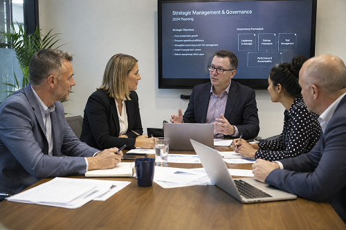 SME leadership team discussing strategic management and governance planning