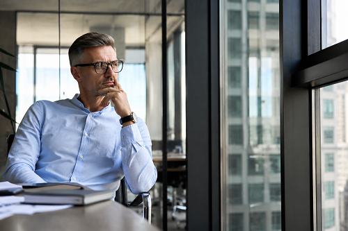 Business leader reflecting on leadership mindset and strategic growth