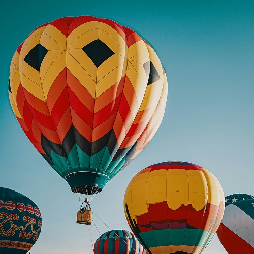 Hot air balloons soaring into the sky, symbolizing missed and seized opportunities.