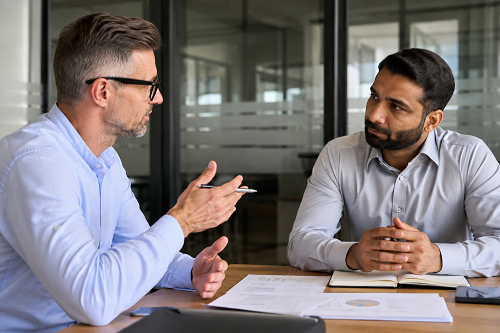 Trusted advisor discussing strategy with business founder