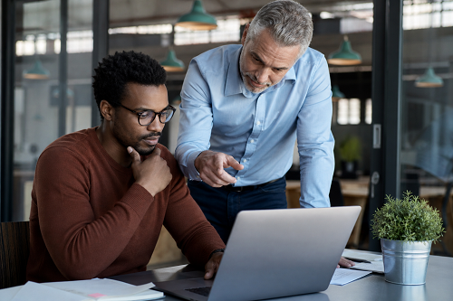 Business mentor listening to entrepreneur during strategic discussion