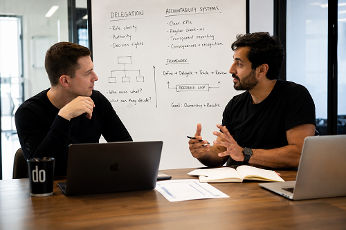 Founder discussing delegation and accountability systems with consultant