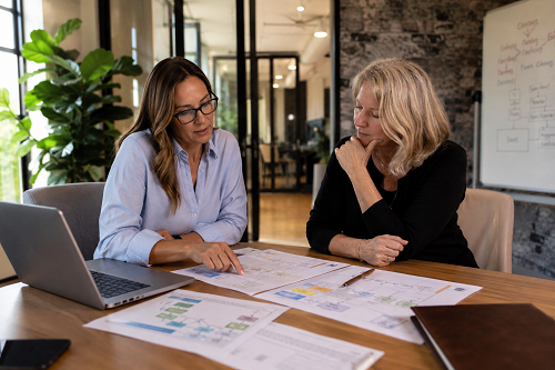 Small business leadership reviewing operational systems with consultant