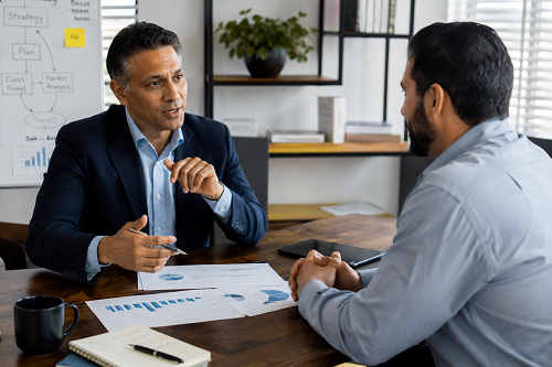 Strategic advisor discussing organisational growth with entrepreneur