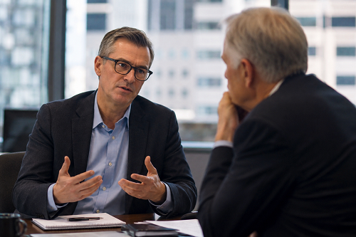 Business leader discussing strategic uncertainty with advisor