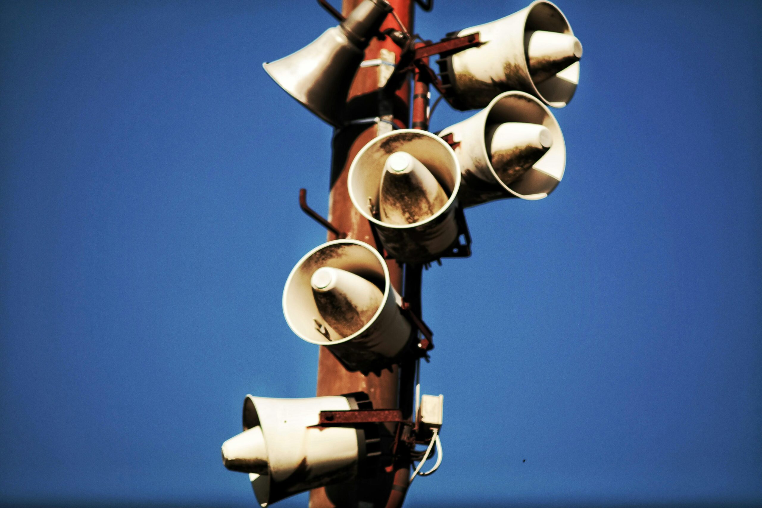 speakers on a post symbolizing some strategies for clear communication.