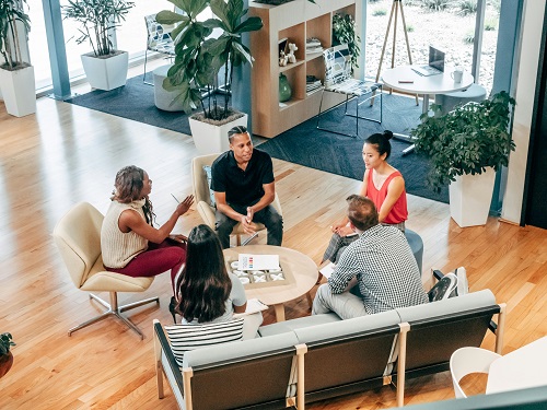 A team of professionals working together in a modern, eco-friendly office.