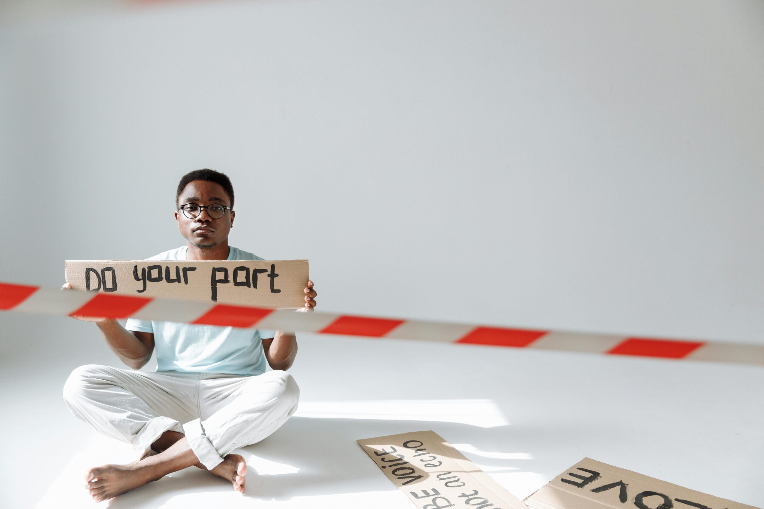 a person holding a banner written do your part, showcasing importance of personal responsibility.