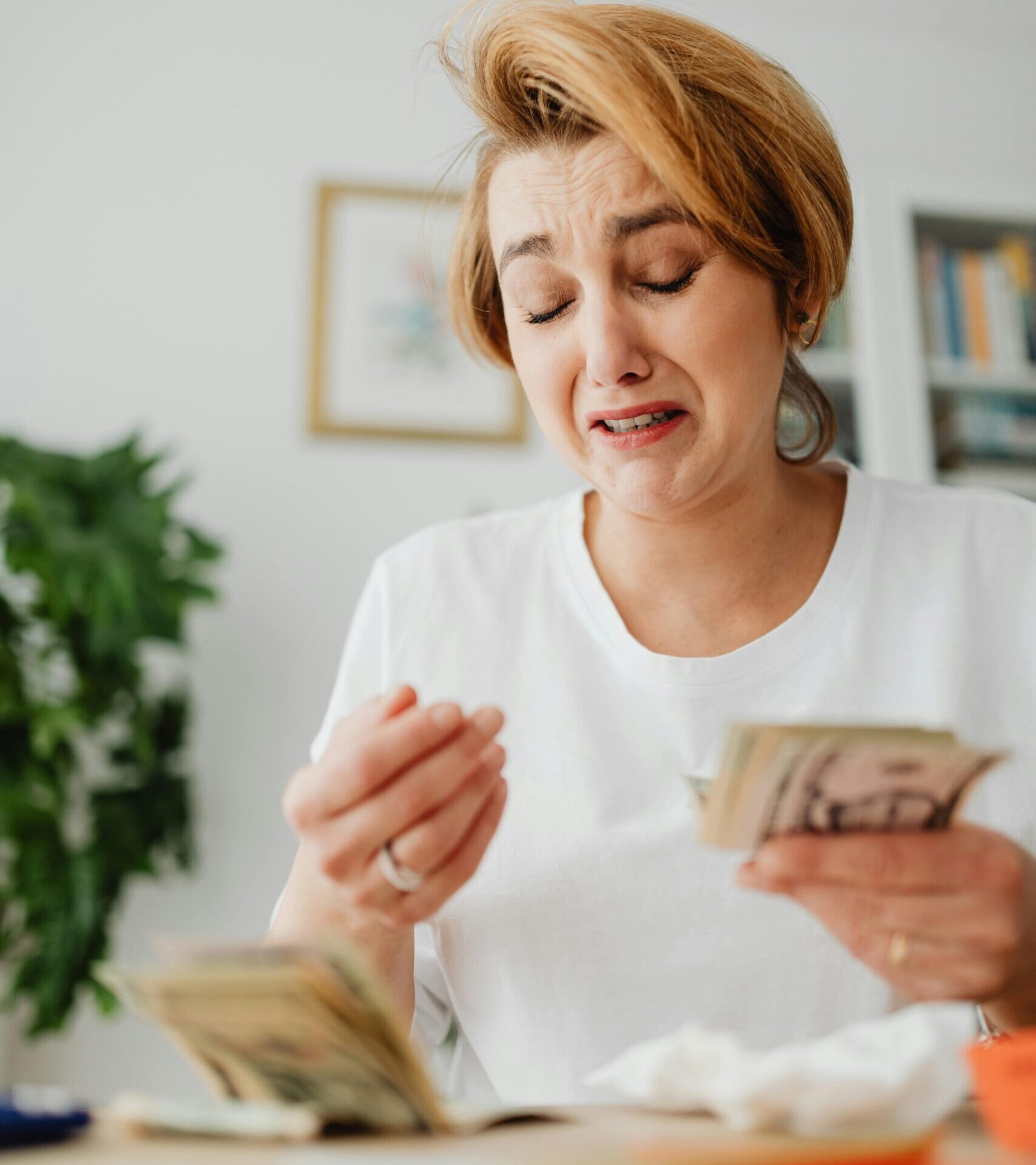 A woman counting money to showcase protecting your business during inflation